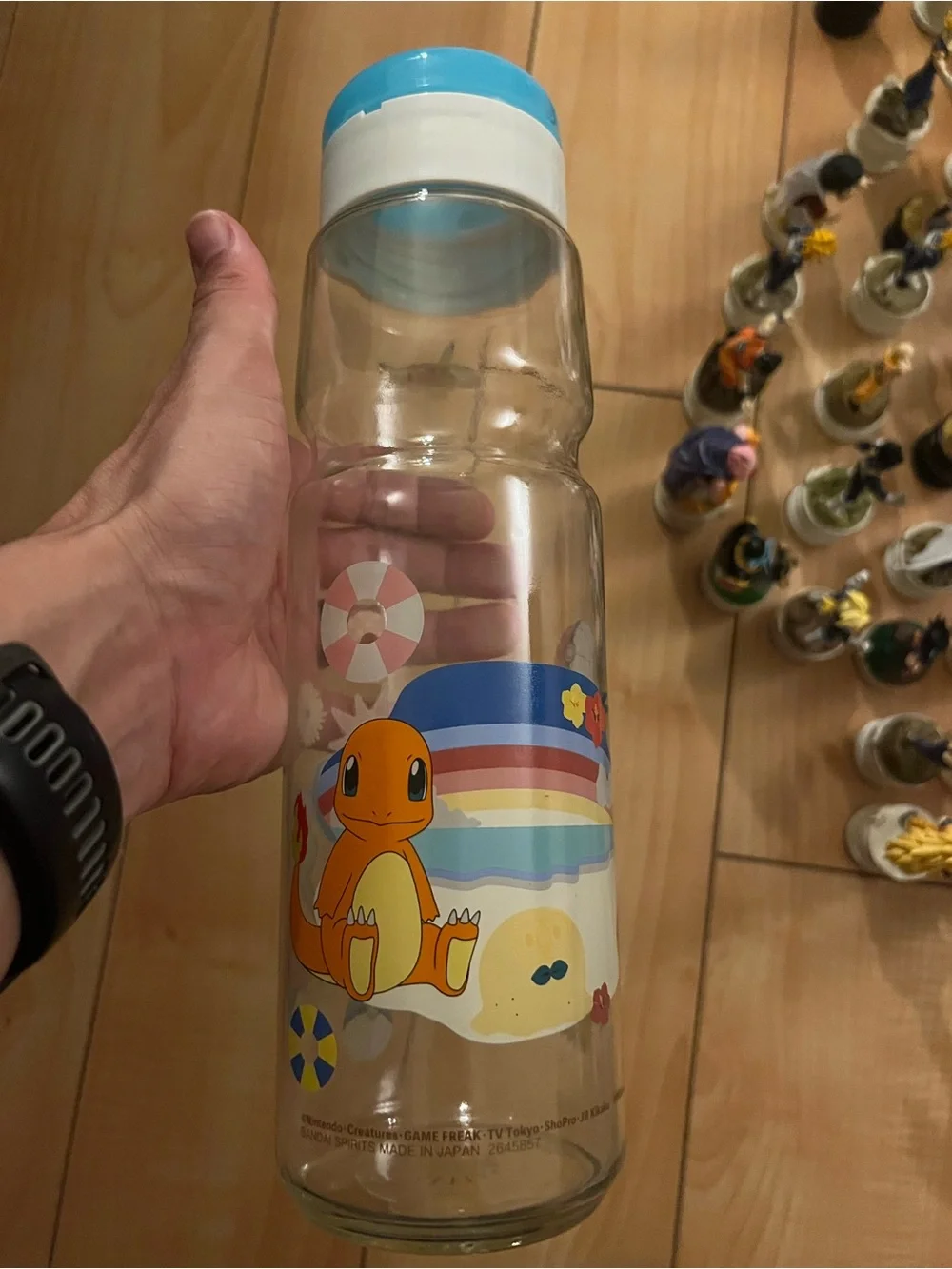 Pokemon Charmander Clear Water Bottle with Blue Cap and Rainbow Beach Art